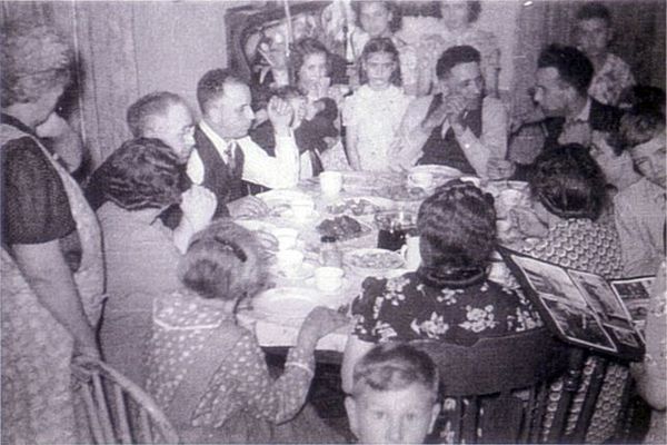 A family meal, perhaps a Sunday chicken dinner, late 1930's